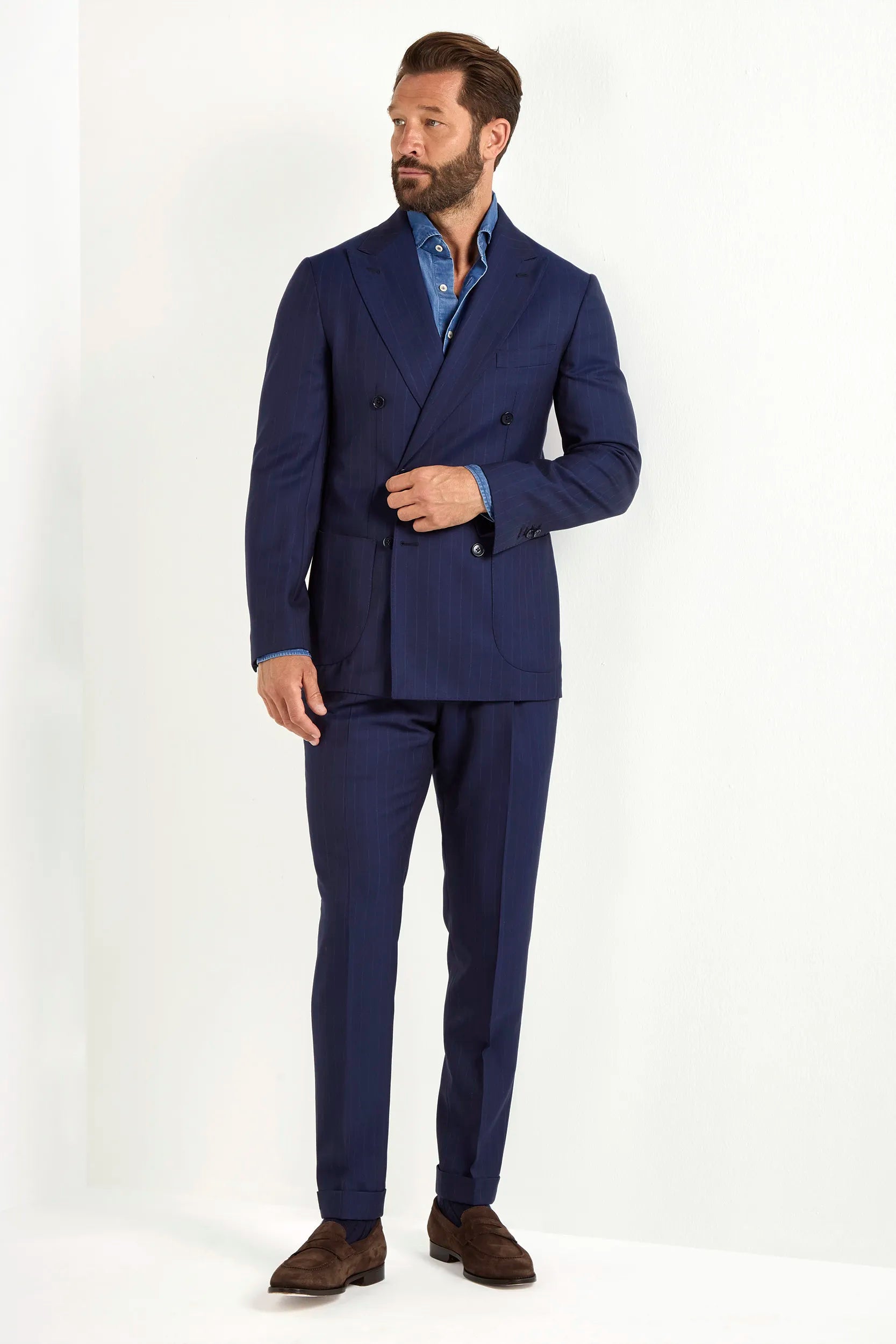 Blue double-breasted striped suit, Italian style, made in Italy, tailored luxury suit, elegant menswear suit, refined formal suit, premium Italian craftsmanship, classic striped suit, sophisticated business suit, smart formal attire, versatile modern suit, polished double-breasted blazer, fine Italian tailoring, upscale menswear suit, timeless Italian suit, refined professional look, sharp tailored suit, luxury office suit, contemporary striped blazer, Italian elegance suit