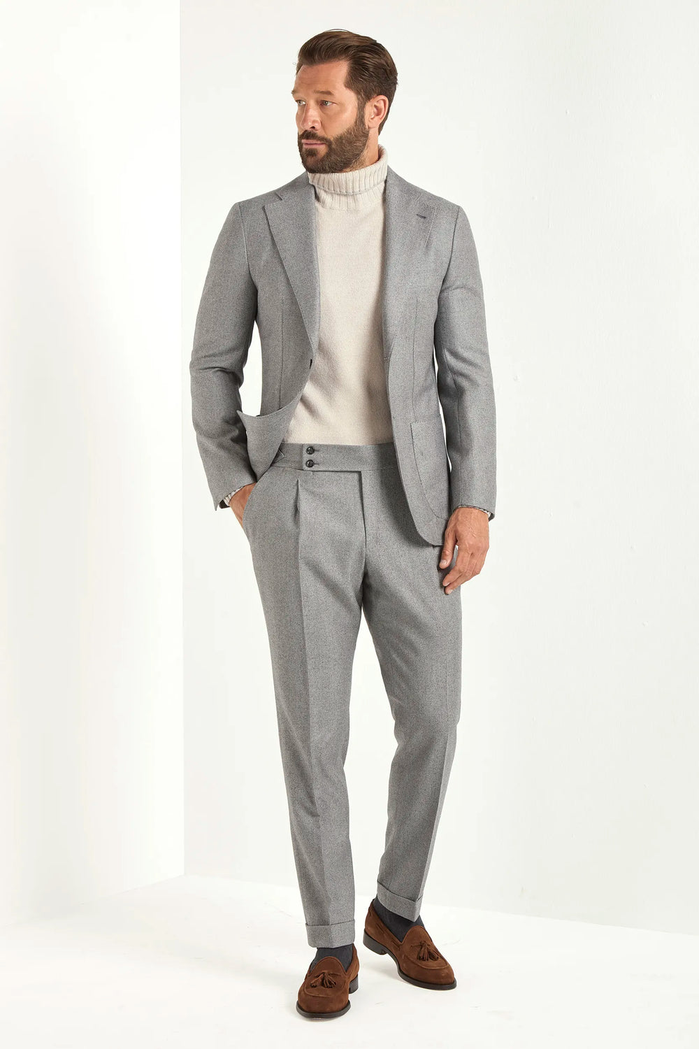 Light grey herringbone suit, Italian style, made in Italy, tailored luxury suit, elegant menswear suit, refined formalwear, premium Italian craftsmanship, classic herringbone weave suit, sophisticated business suit, smart formal attire, versatile modern suit, polished two-piece suit, fine Italian tailoring, upscale menswear suit, timeless Italian suit, refined professional look, sharp tailored suit, luxury office suit, contemporary herringbone blazer, Italian elegance suit