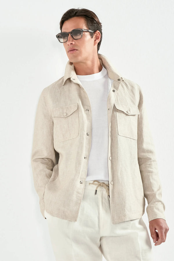 Man wearing a beige jacket, white shirt, and pants against a white background