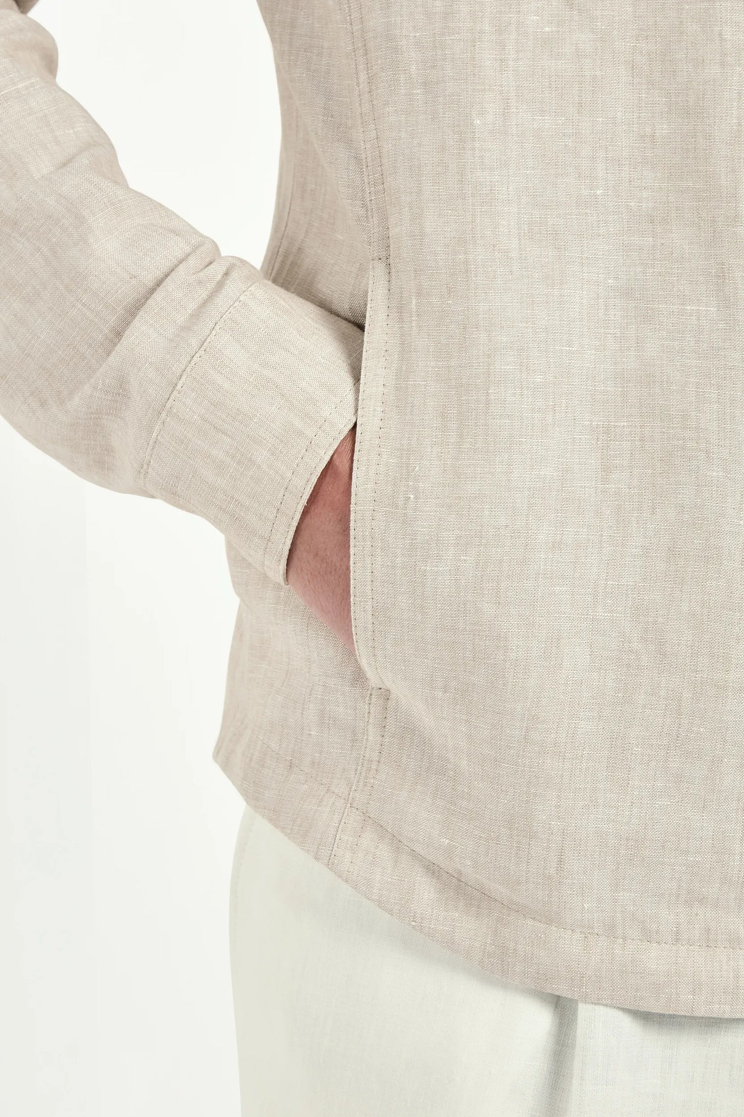 Close-up of a beige textured shirt with a white background
