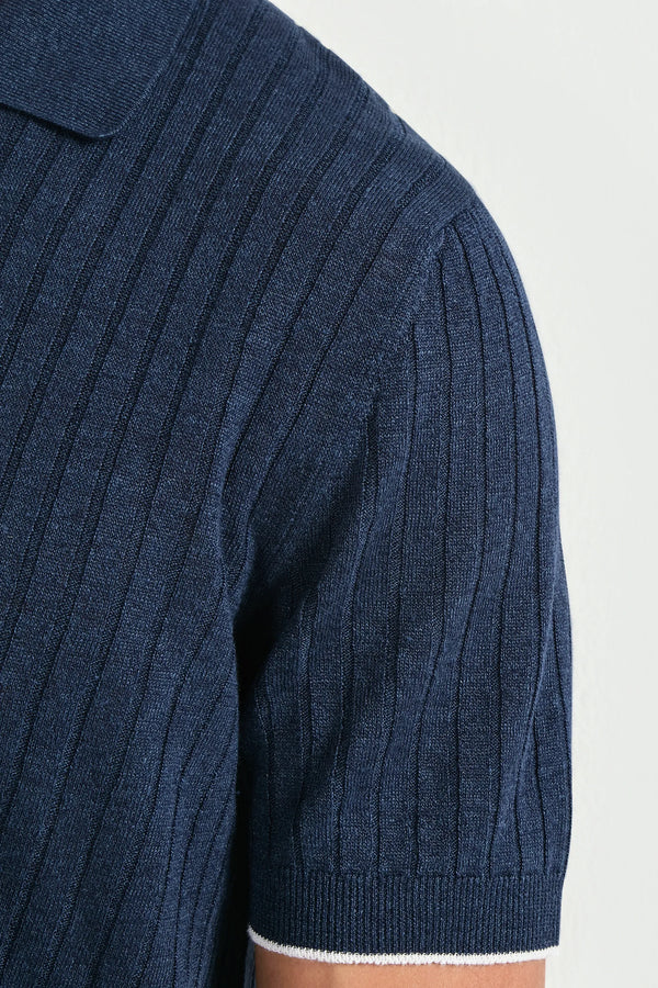 Navy blue ribbed sweater on a light gray background