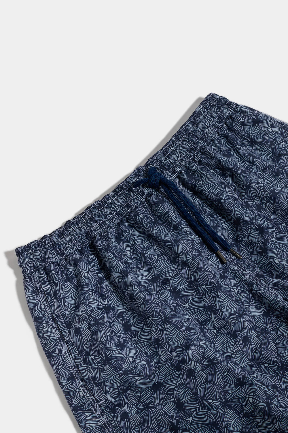 Navy blue shorts with a subtle pattern on a white background