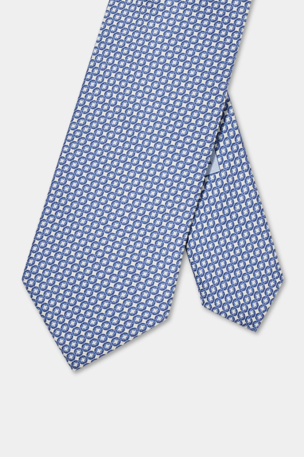 Blue patterned tie on a light gray background