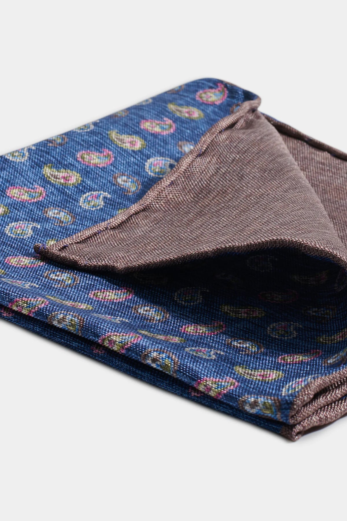 Folded fabric with paisley pattern on a white background