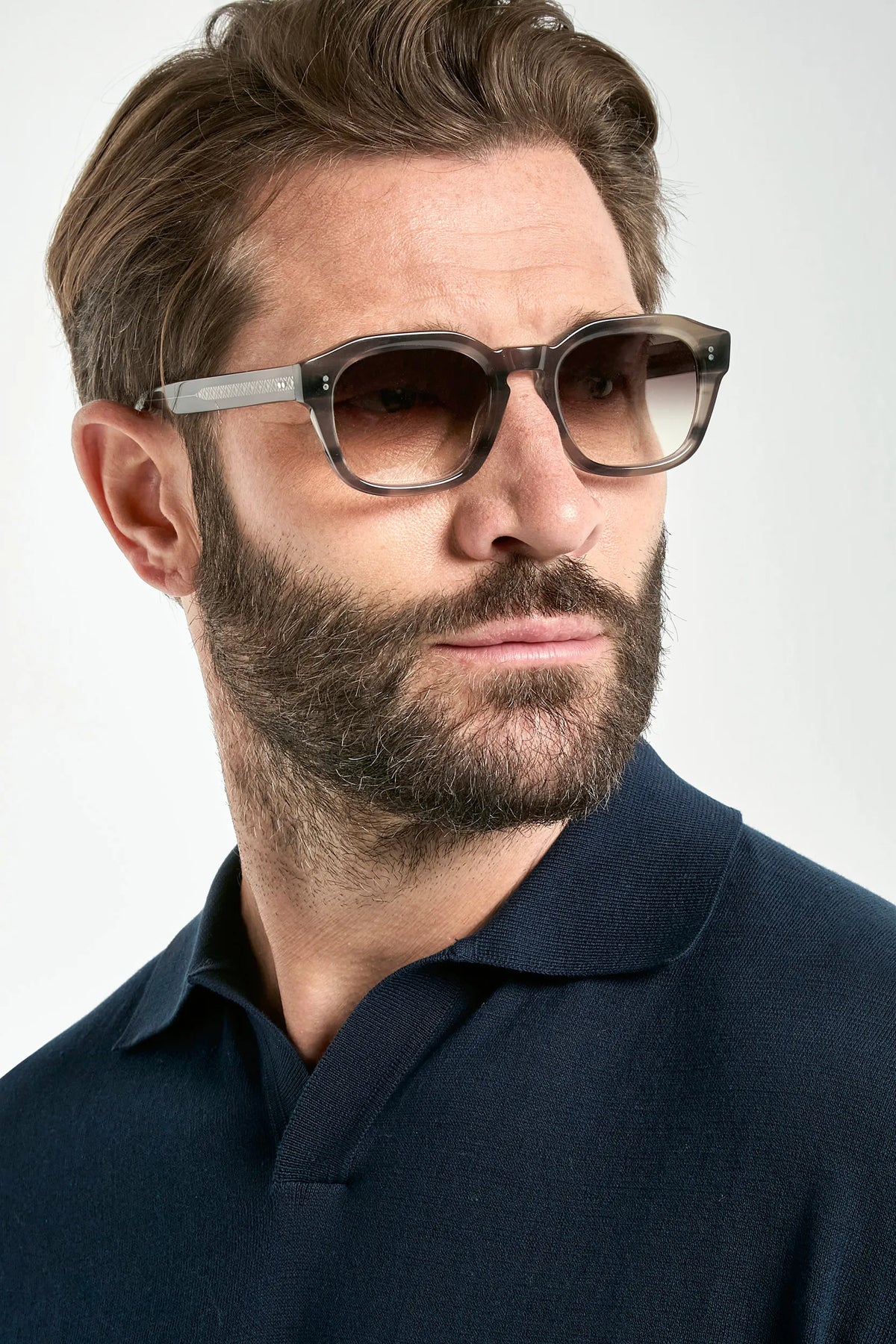 Man wearing sunglasses with a neutral background