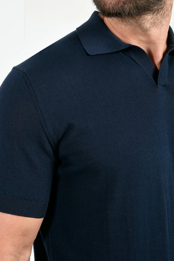 Navy blue polo shirt worn by a person on a white background