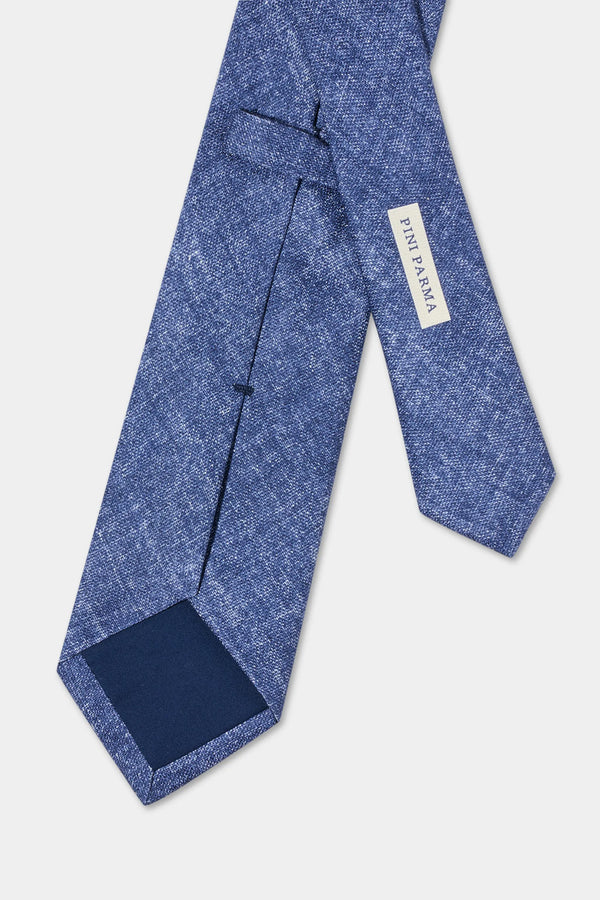Blue tie with a visible brand label on a light gray background