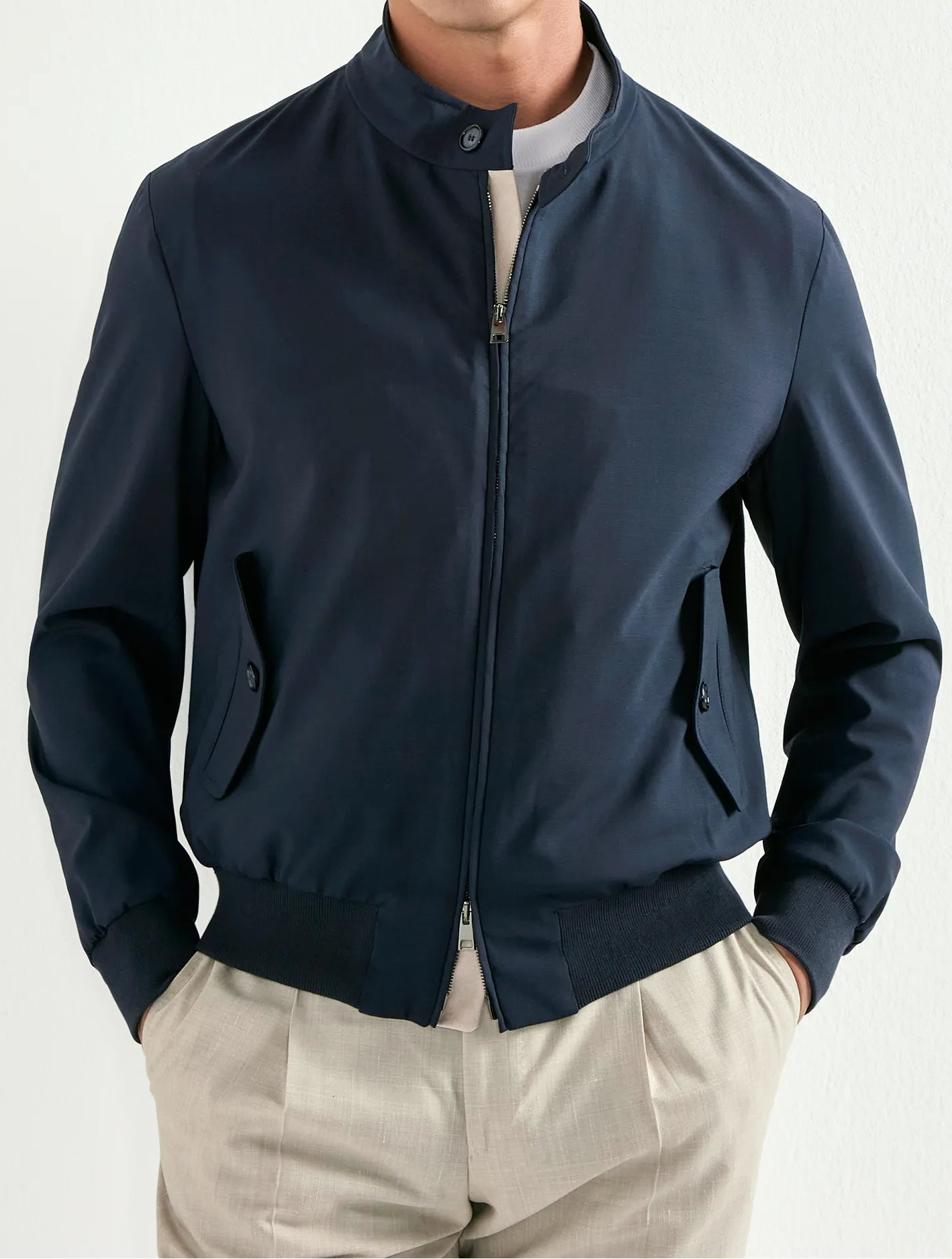 Man wearing a navy blue jacket on a white background