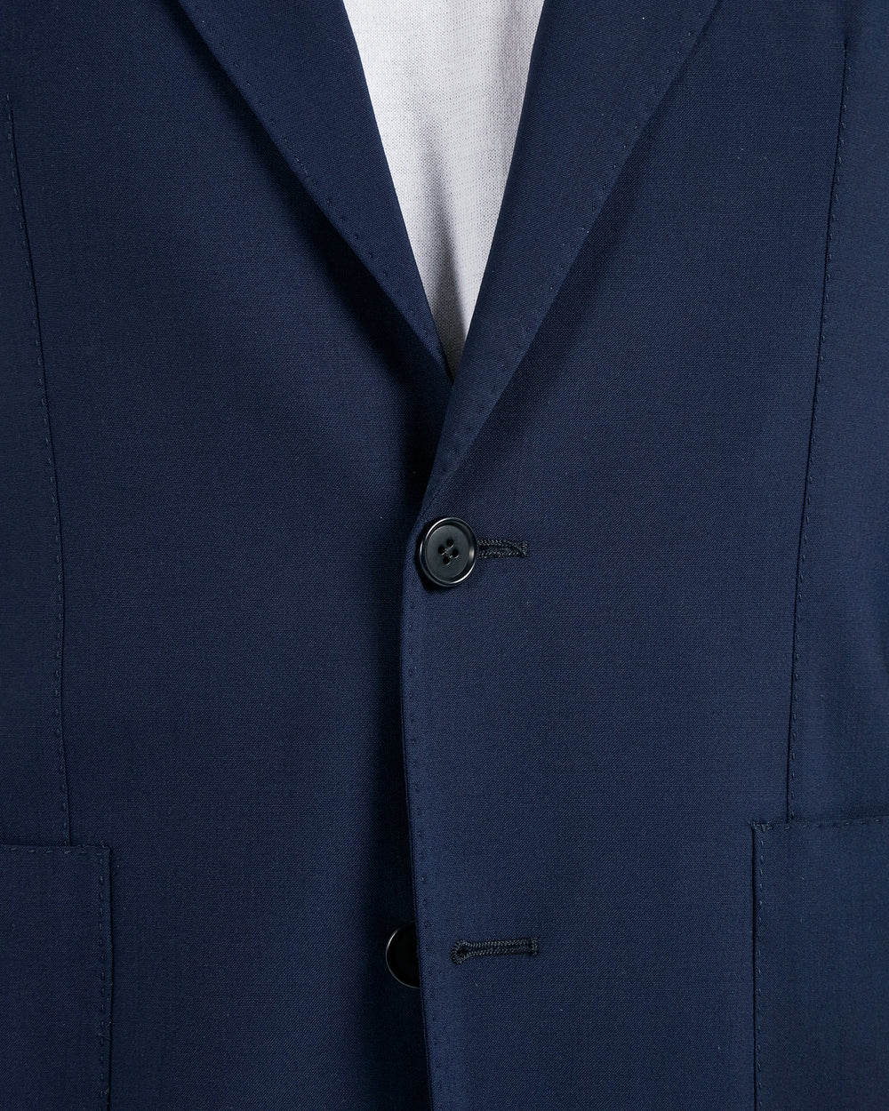 Close-up of a navy blue suit jacket with a button