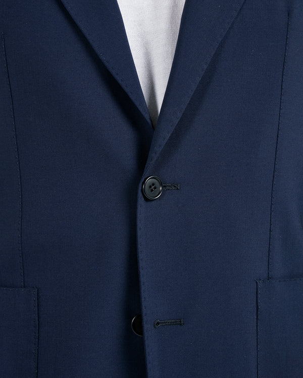 Close-up of a navy blue suit jacket with a button