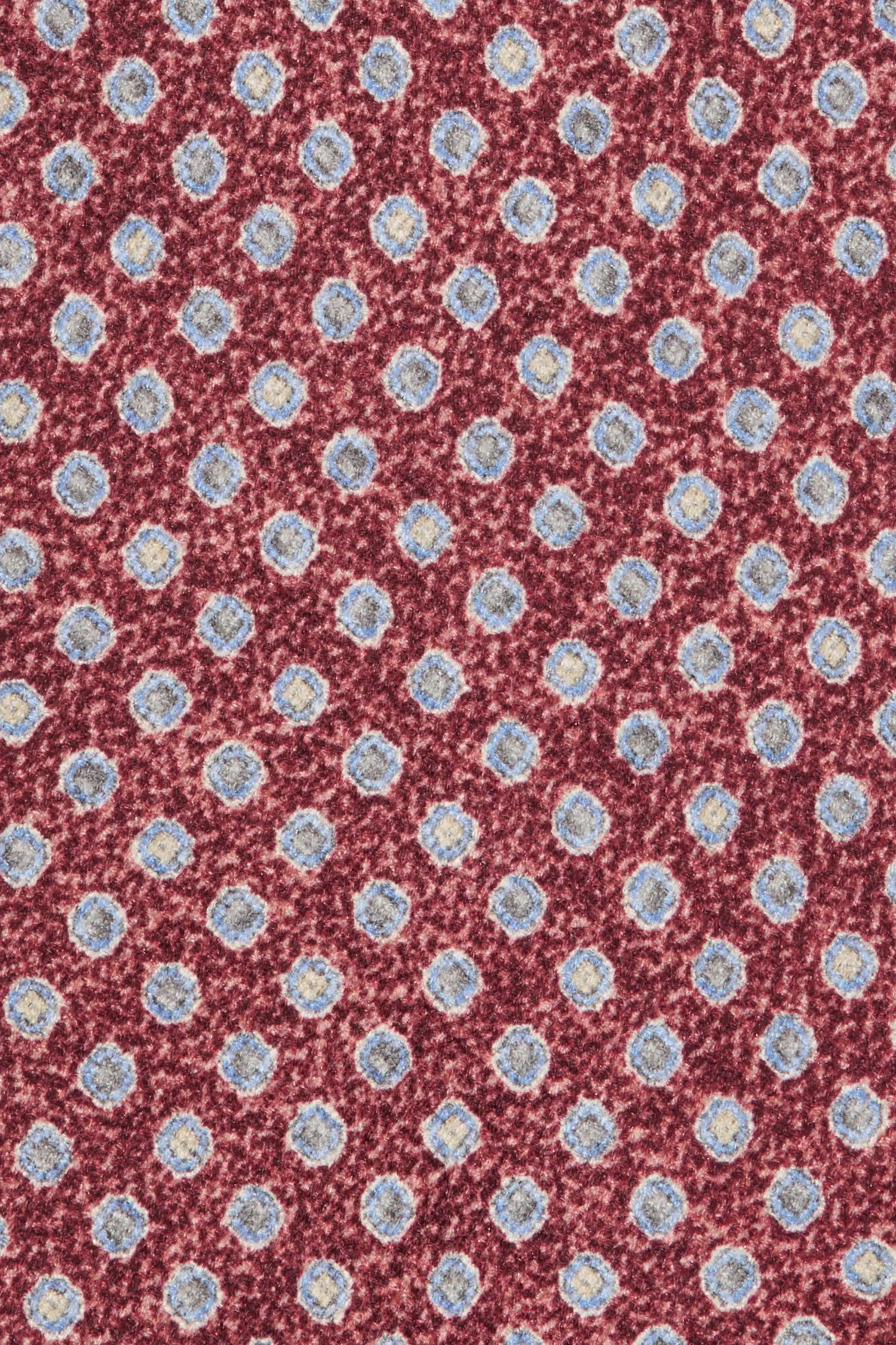 Patterned fabric with small blue flowers on a red background