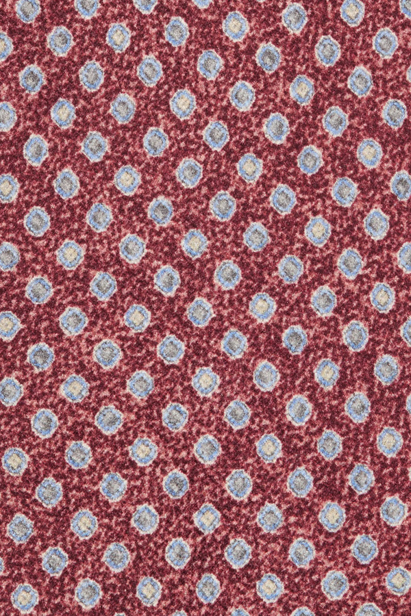 Patterned fabric with small blue flowers on a red background