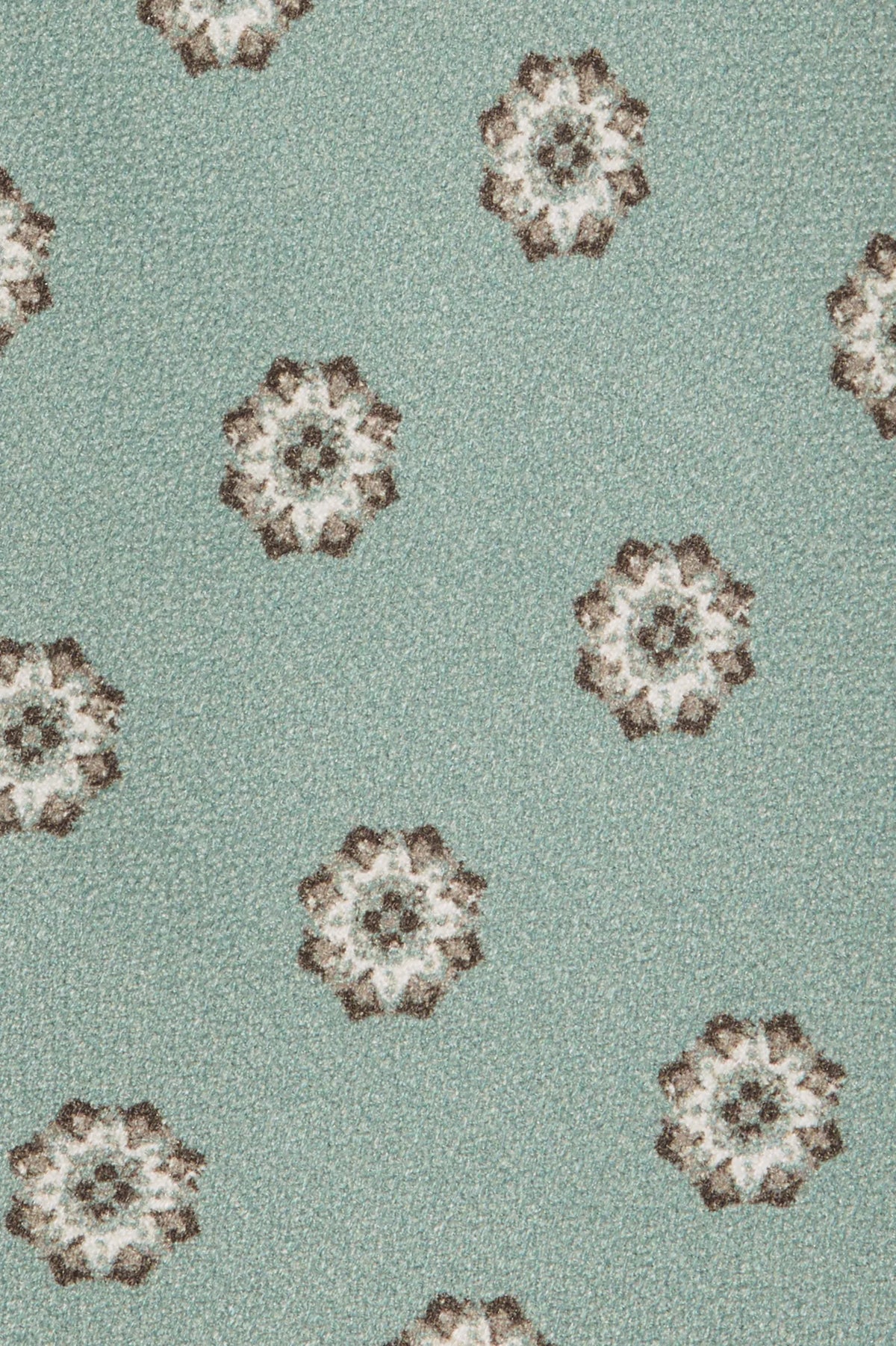 Patterned fabric with floral designs on a light green background