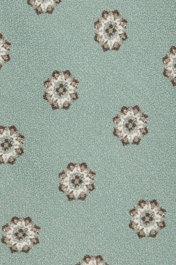 Patterned fabric with floral designs on a light green background