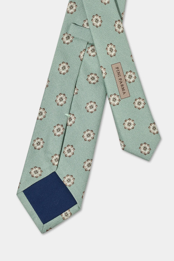 Green floral patterned tie on a light gray background