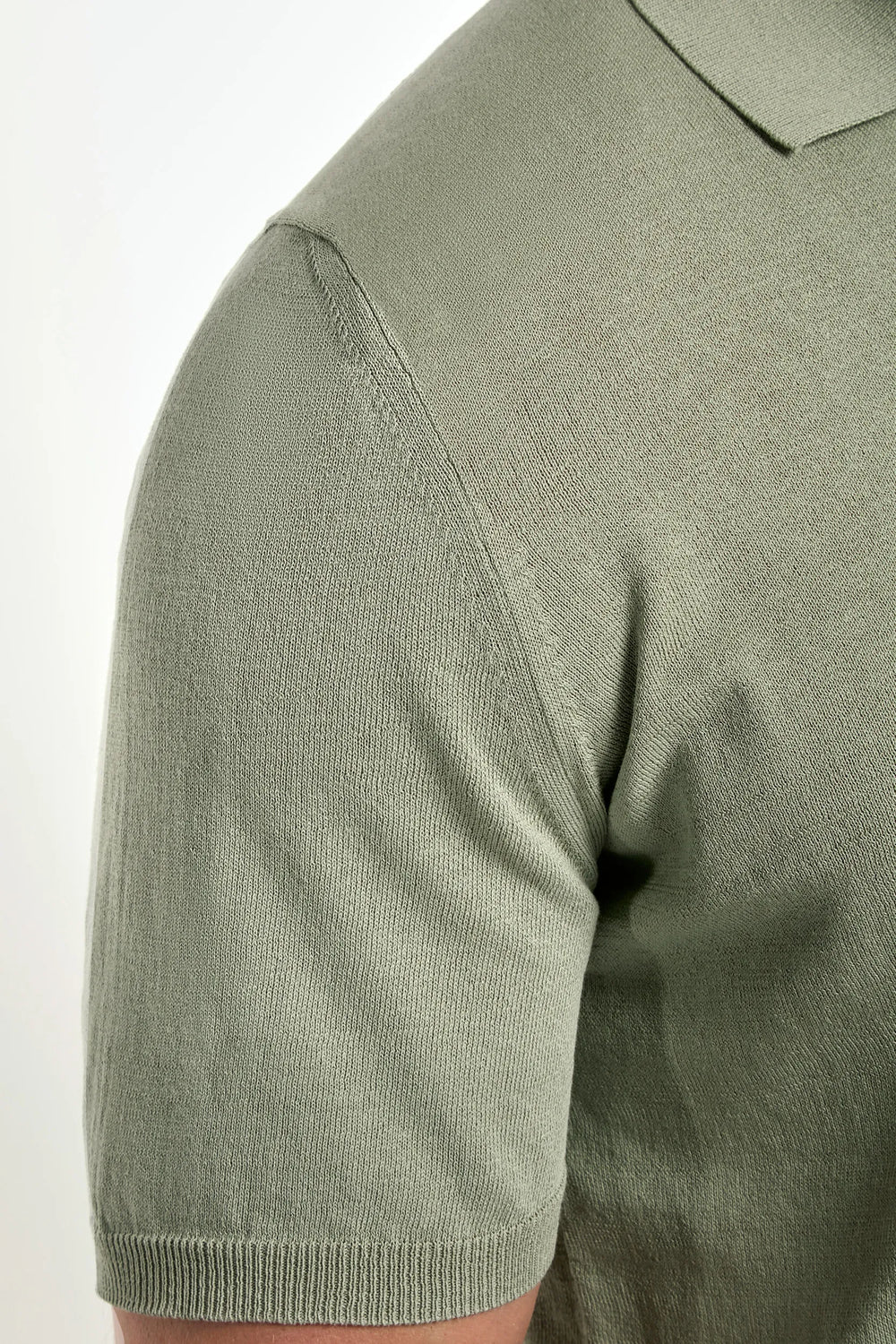 Close-up of a green polo shirt on a white background