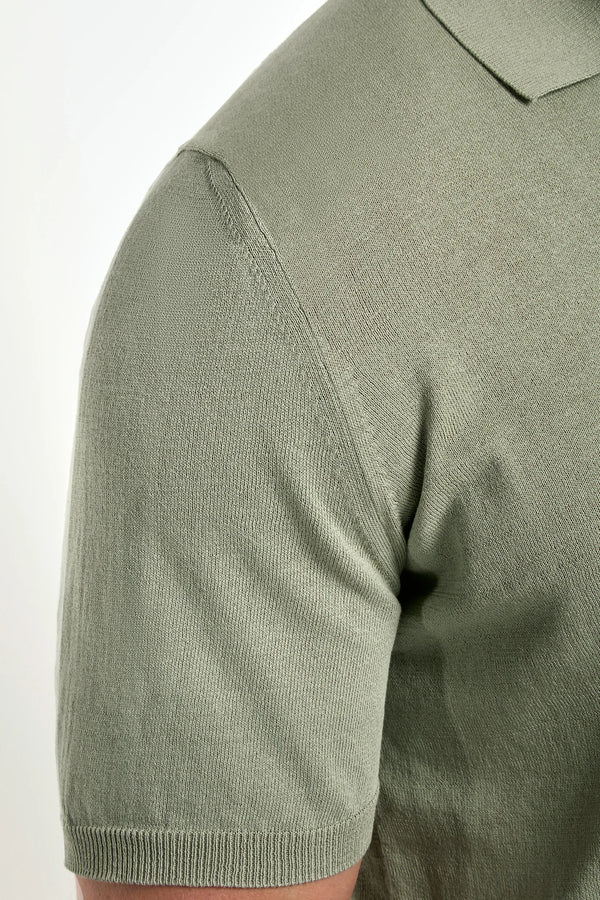 Close-up of a green polo shirt on a white background
