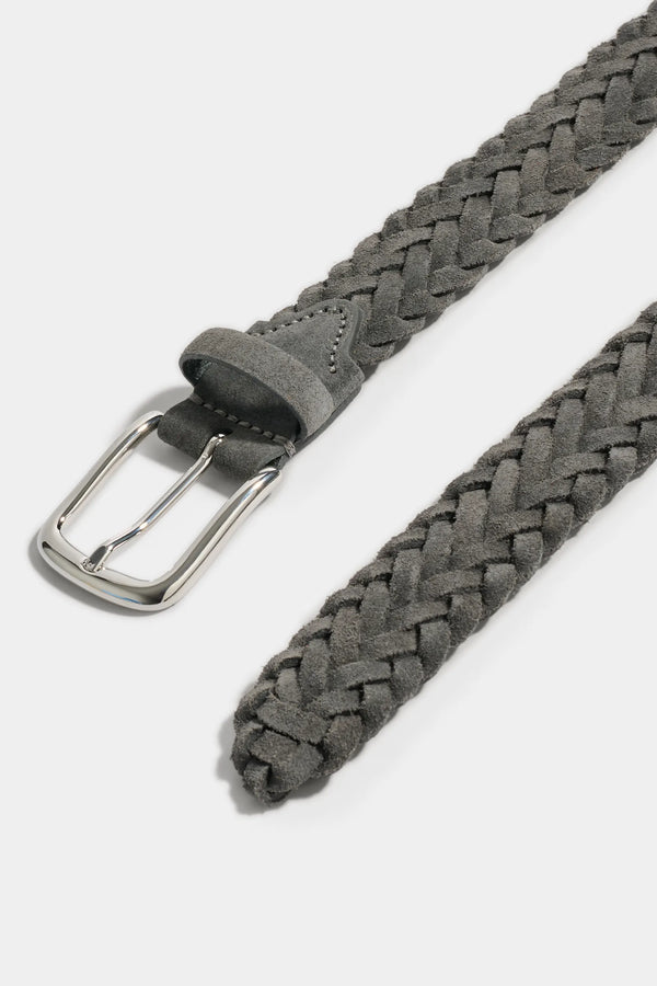 Grey belt with silver buckle on a light background 