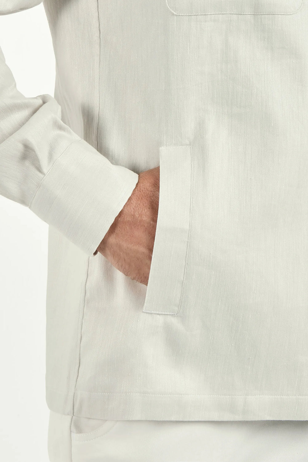 close up of a hand inside a jacket pocket 