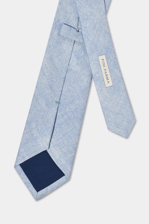 Light blue tie with a navy patch on a white background