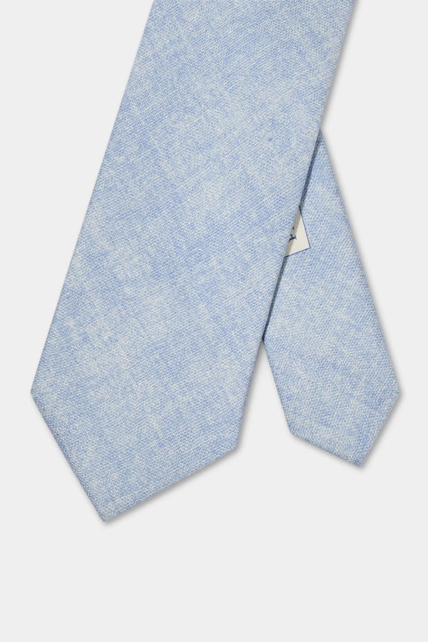 Light blue textured tie on a light gray background