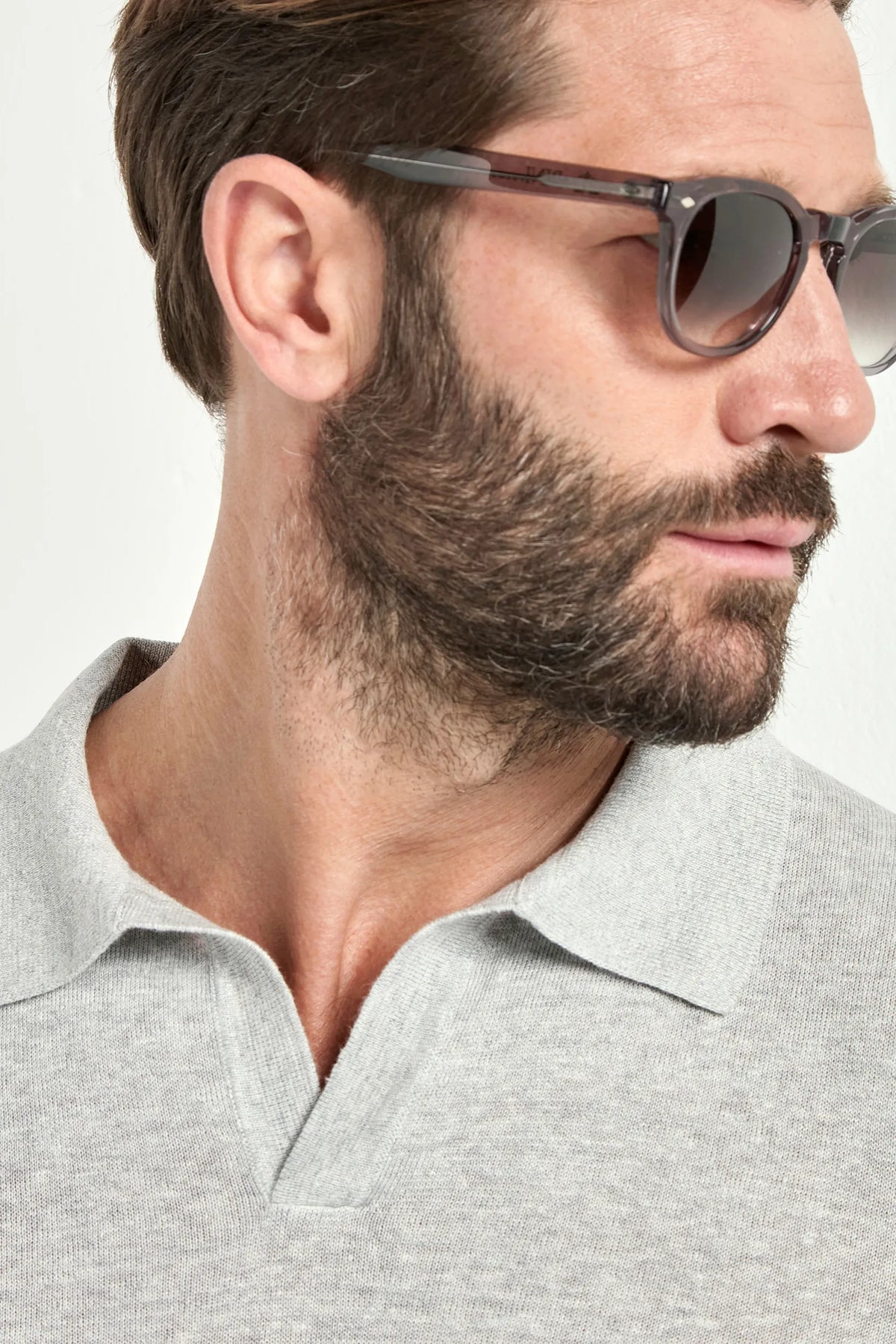 Man wearing sunglasses with a neutral background