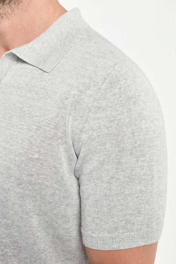 Gray short-sleeve shirt worn by a person on a white background