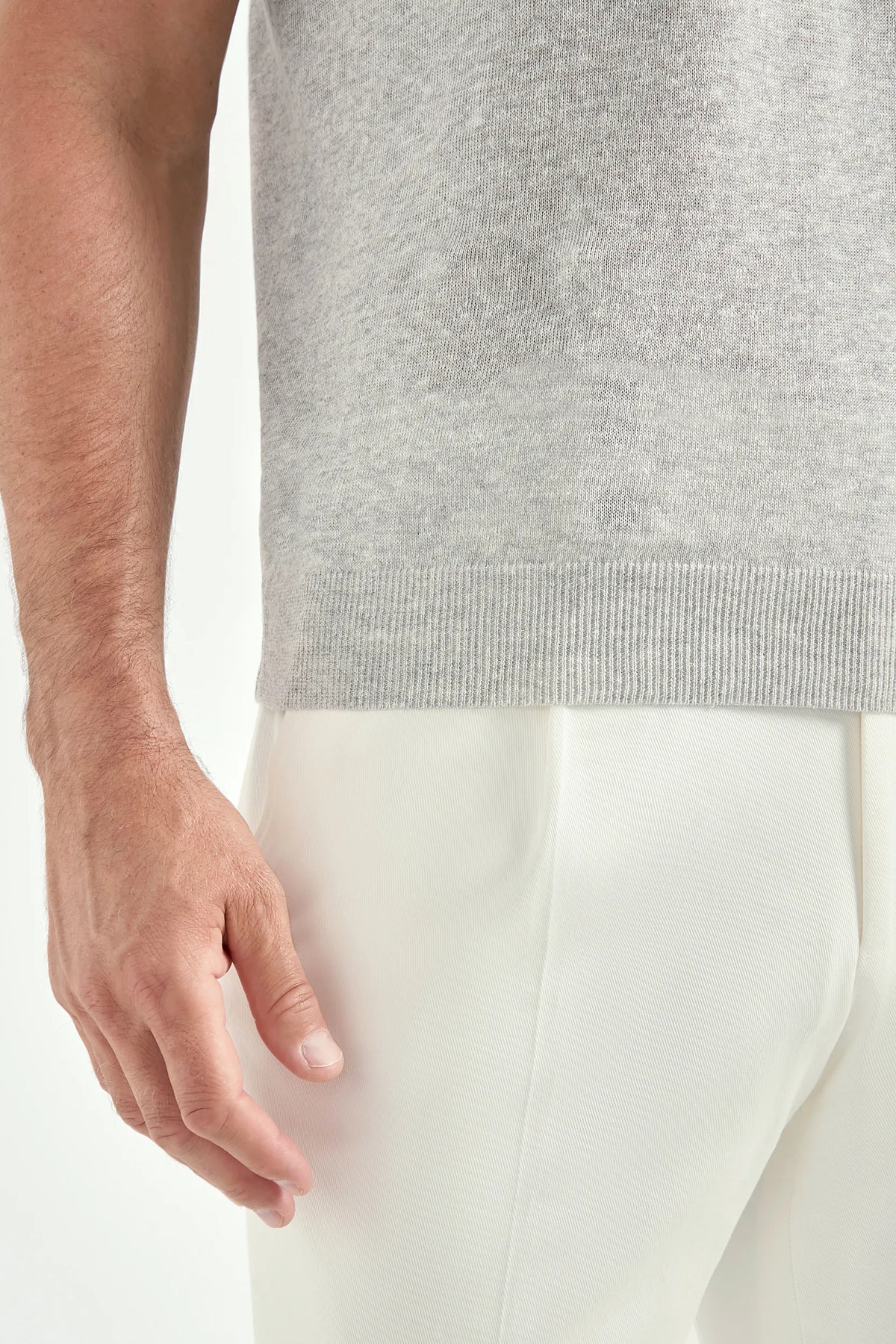Gray sleeveless top worn by a person with a white background