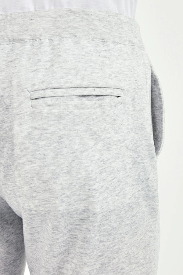 Close-up of gray sweatpants with a pocket on a white background