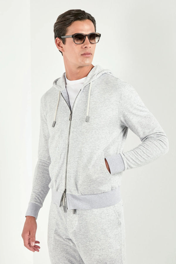 Man wearing a gray hoodie and pants on a white background
