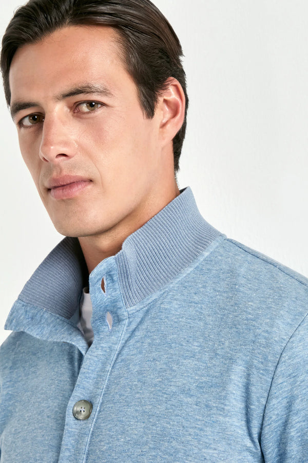 Man wearing a light blue sweater against a white background
