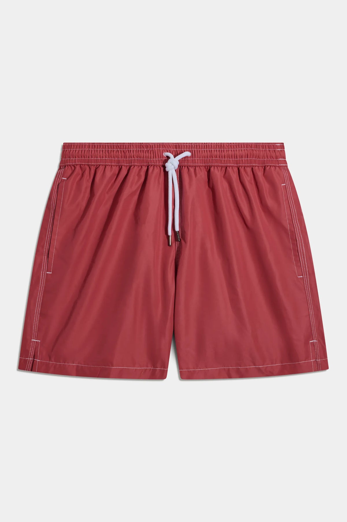 Red shorts with a white drawstring on a light gray background