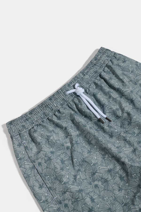 Green patterned shorts with a drawstring on a white background