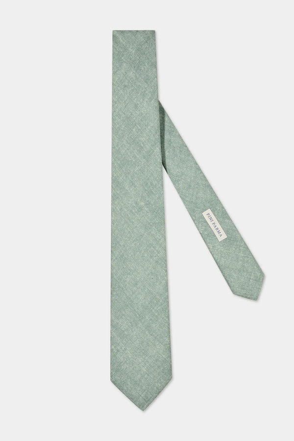 Green tie with a brand label on a white background