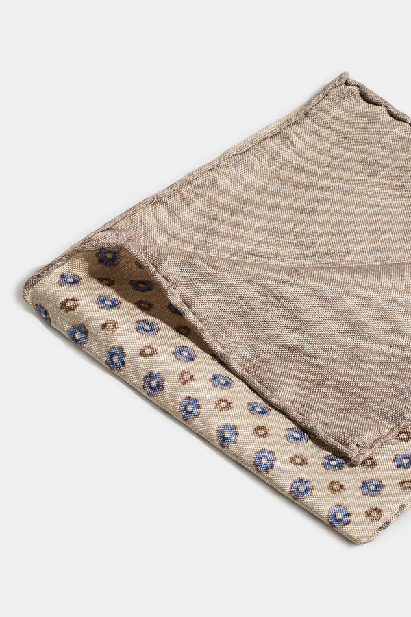 Two beige fabric pockets with floral patterns on a white background