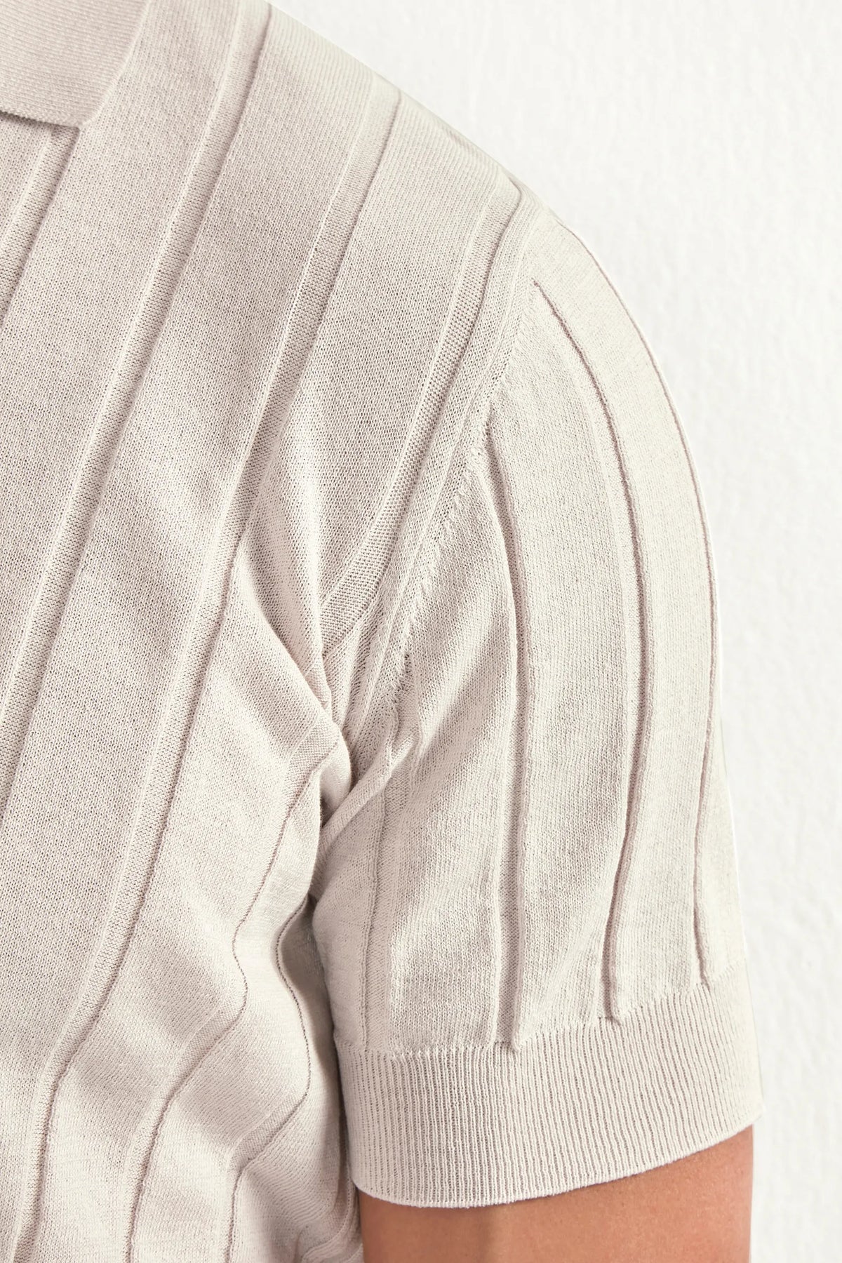 Close-up of a beige short-sleeve cardigan on a white background
