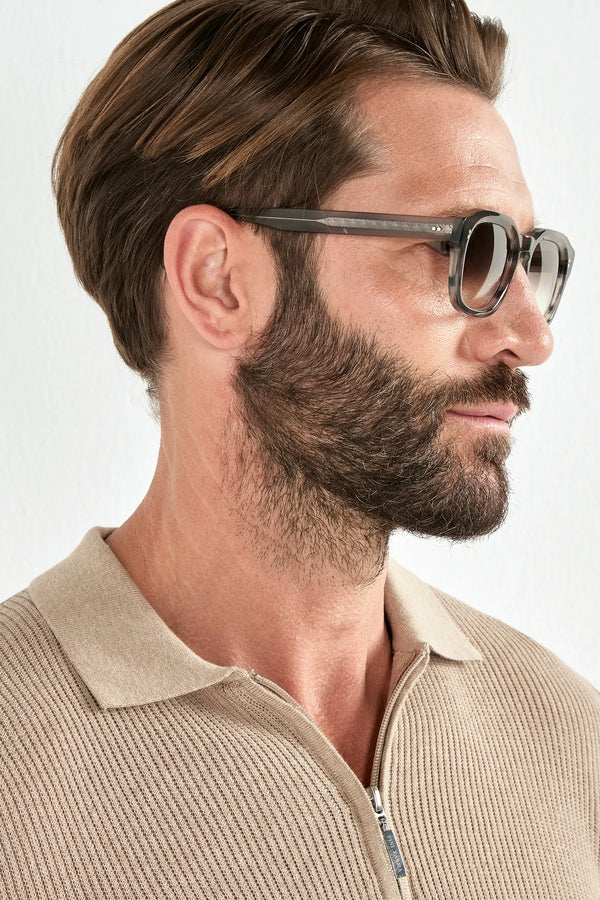 Man wearing sunglasses with a neutral background