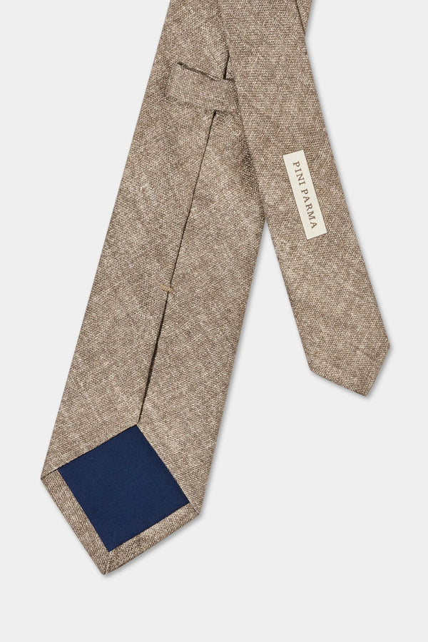 Beige patterned tie with a blue patch on a white background