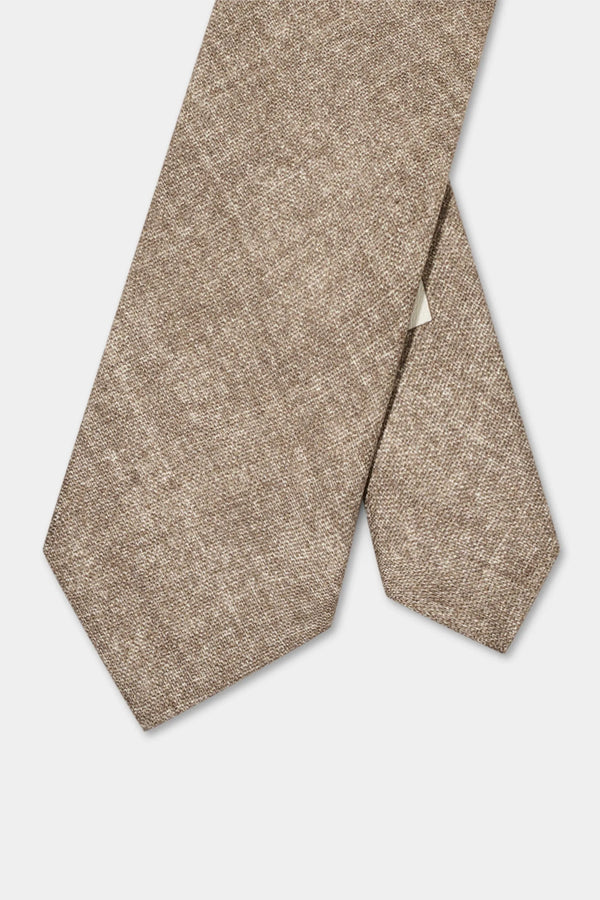 Beige textured tie on a light gray background