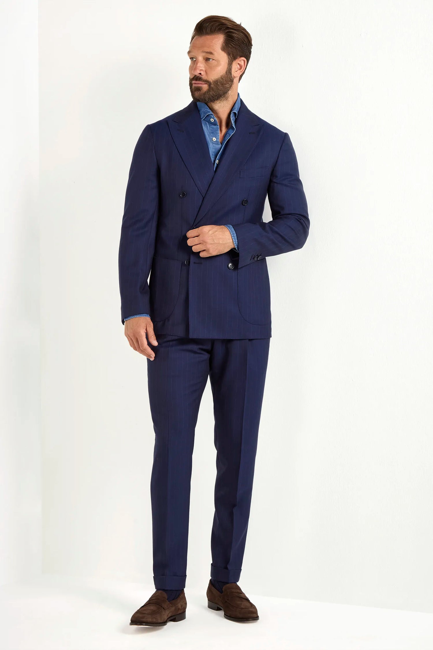 Blue double-breasted striped suit, Italian style, made in Italy, tailored luxury suit, elegant menswear suit, refined formal suit, premium Italian craftsmanship, classic striped suit, sophisticated business suit, smart formal attire, versatile modern suit, polished double-breasted blazer, fine Italian tailoring, upscale menswear suit, timeless Italian suit, refined professional look, sharp tailored suit, luxury office suit, contemporary striped blazer, Italian elegance suit