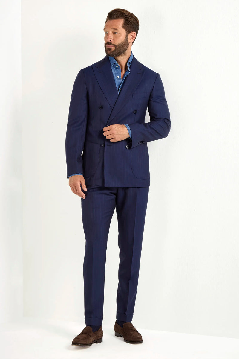 Blue double-breasted striped suit, Italian style, made in Italy, tailored luxury suit, elegant menswear suit, refined formal suit, premium Italian craftsmanship, classic striped suit, sophisticated business suit, smart formal attire, versatile modern suit, polished double-breasted blazer, fine Italian tailoring, upscale menswear suit, timeless Italian suit, refined professional look, sharp tailored suit, luxury office suit, contemporary striped blazer, Italian elegance suit