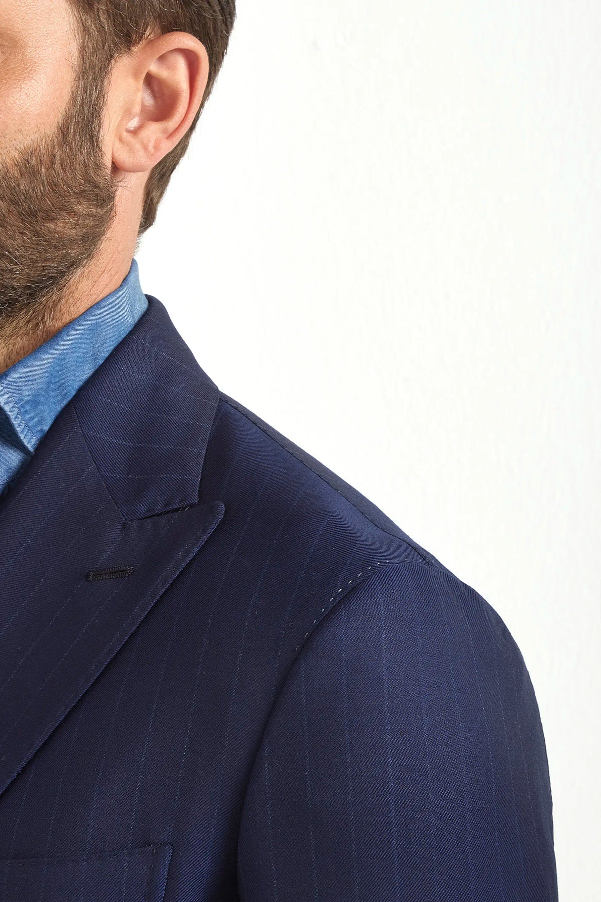 Blue double-breasted striped suit, Italian style, made in Italy, tailored luxury suit, elegant menswear suit, refined formal suit, premium Italian craftsmanship, classic striped suit, sophisticated business suit, smart formal attire, versatile modern suit, polished double-breasted blazer, fine Italian tailoring, upscale menswear suit, timeless Italian suit, refined professional look, sharp tailored suit, luxury office suit, contemporary striped blazer, Italian elegance suit