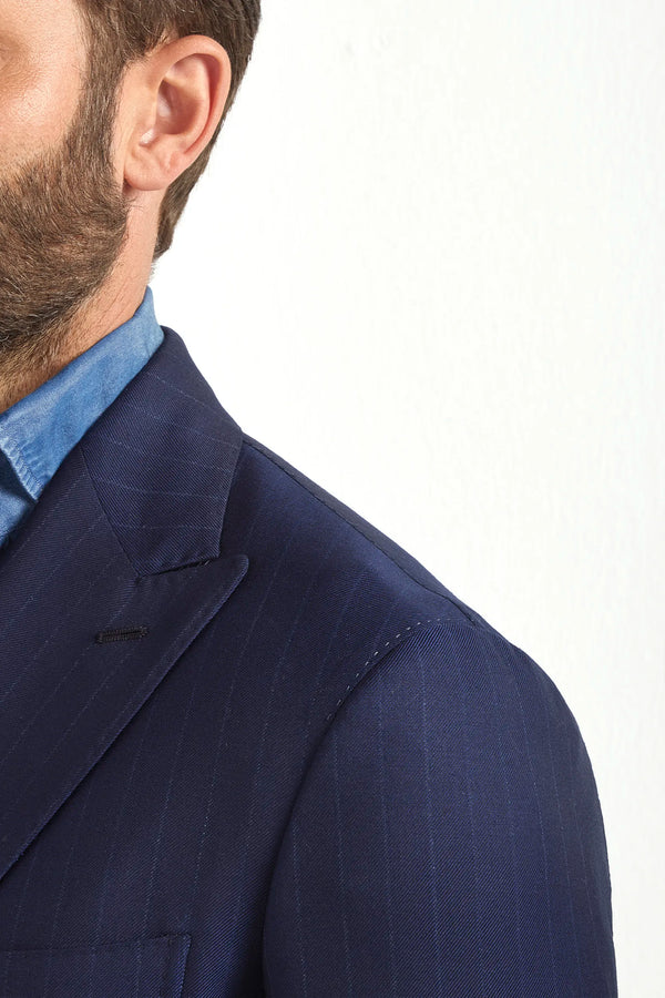 Blue double-breasted striped suit, Italian style, made in Italy, tailored luxury suit, elegant menswear suit, refined formal suit, premium Italian craftsmanship, classic striped suit, sophisticated business suit, smart formal attire, versatile modern suit, polished double-breasted blazer, fine Italian tailoring, upscale menswear suit, timeless Italian suit, refined professional look, sharp tailored suit, luxury office suit, contemporary striped blazer, Italian elegance suit