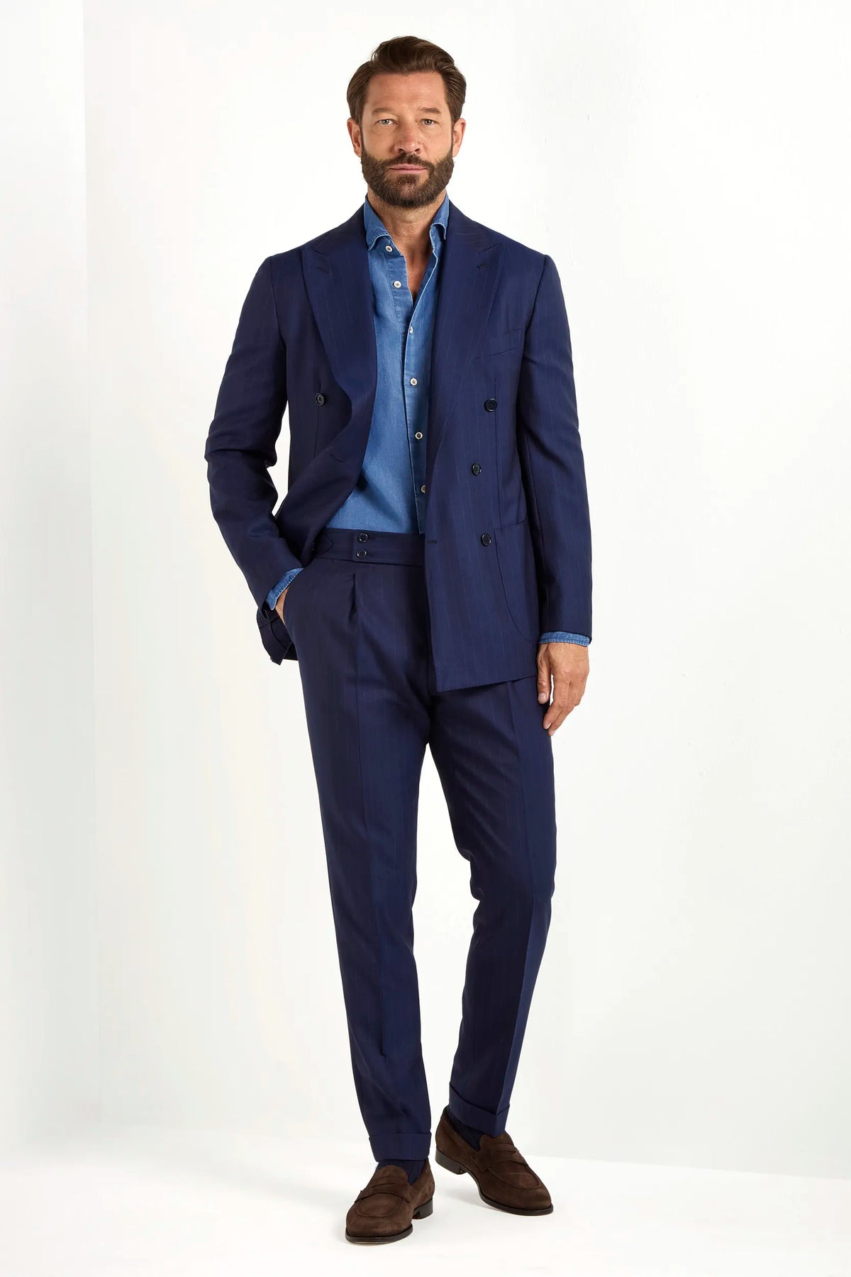 Blue double-breasted striped suit, Italian style, made in Italy, tailored luxury suit, elegant menswear suit, refined formal suit, premium Italian craftsmanship, classic striped suit, sophisticated business suit, smart formal attire, versatile modern suit, polished double-breasted blazer, fine Italian tailoring, upscale menswear suit, timeless Italian suit, refined professional look, sharp tailored suit, luxury office suit, contemporary striped blazer, Italian elegance suit