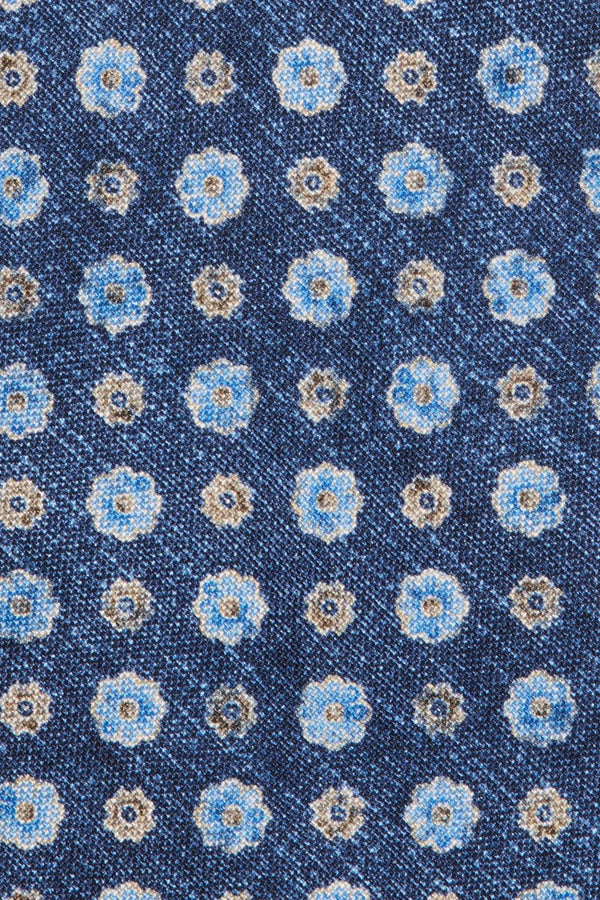 Navy blue fabric with a pattern of small flowers in white, light blue, and beige.