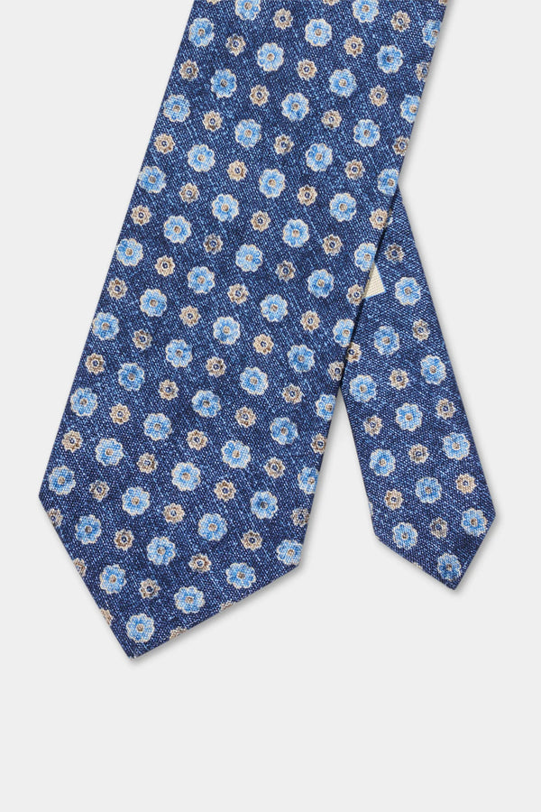 Blue floral patterned tie on a light gray background