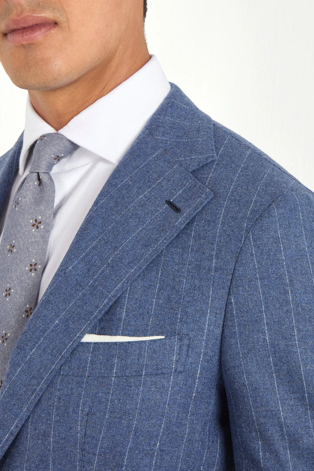 Light blue striped suit, Italian style, made in Italy, tailored luxury suit, elegant menswear suit, refined formalwear, premium Italian craftsmanship, classic striped suit, sophisticated business suit, smart formal attire, versatile modern suit, polished two-piece suit, fine Italian tailoring, upscale menswear suit, timeless Italian suit, refined professional look, sharp tailored suit, luxury office suit, contemporary striped blazer, Italian elegance suit