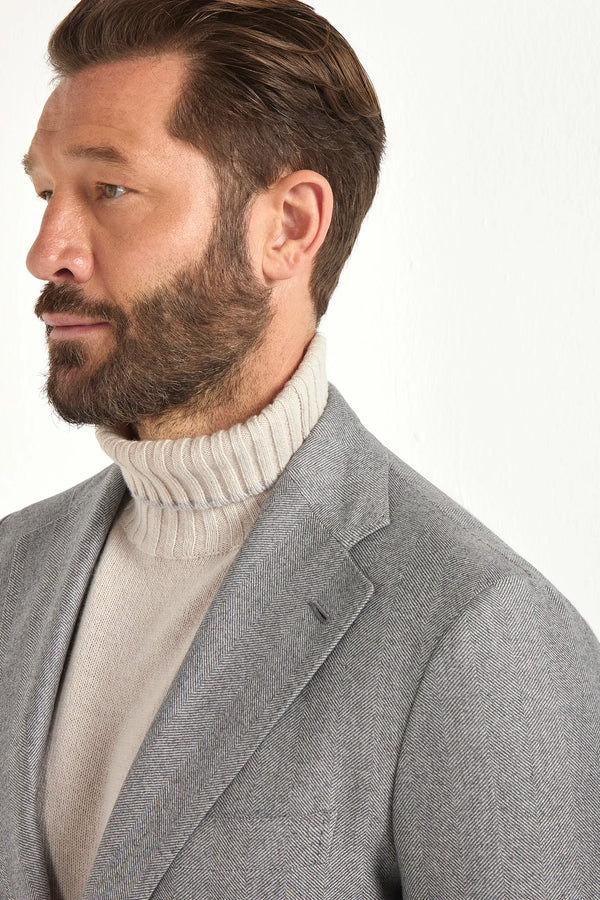 Light grey herringbone suit, Italian style, made in Italy, tailored luxury suit, elegant menswear suit, refined formalwear, premium Italian craftsmanship, classic herringbone weave suit, sophisticated business suit, smart formal attire, versatile modern suit, polished two-piece suit, fine Italian tailoring, upscale menswear suit, timeless Italian suit, refined professional look, sharp tailored suit, luxury office suit, contemporary herringbone blazer, Italian elegance suit