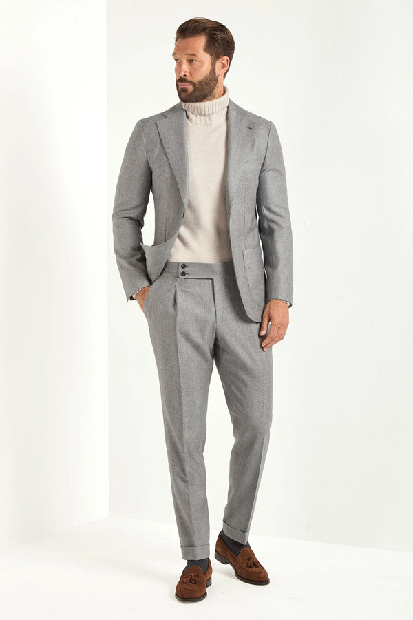 Light grey herringbone suit, Italian style, made in Italy, tailored luxury suit, elegant menswear suit, refined formalwear, premium Italian craftsmanship, classic herringbone weave suit, sophisticated business suit, smart formal attire, versatile modern suit, polished two-piece suit, fine Italian tailoring, upscale menswear suit, timeless Italian suit, refined professional look, sharp tailored suit, luxury office suit, contemporary herringbone blazer, Italian elegance suit