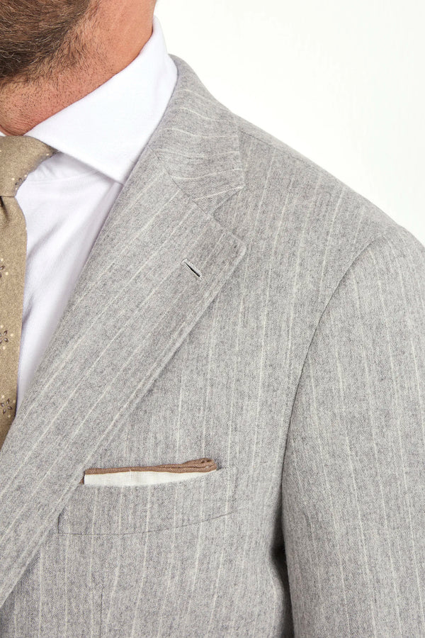 Light grey striped suit, Italian style, made in Italy, tailored luxury suit, elegant menswear suit, refined formalwear, premium Italian craftsmanship, classic striped suit, sophisticated business suit, smart formal attire, versatile modern suit, polished two-piece suit, fine Italian tailoring, upscale menswear suit, timeless Italian suit, refined professional look, sharp tailored suit, luxury office suit, contemporary striped blazer, Italian elegance suit